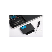 2.5 inch 240GB SATA internal SSD with installation tools beside a laptop